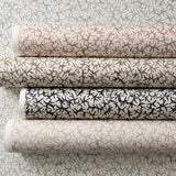 Rolls of wallpaper in watercolor coral design in various colors. 