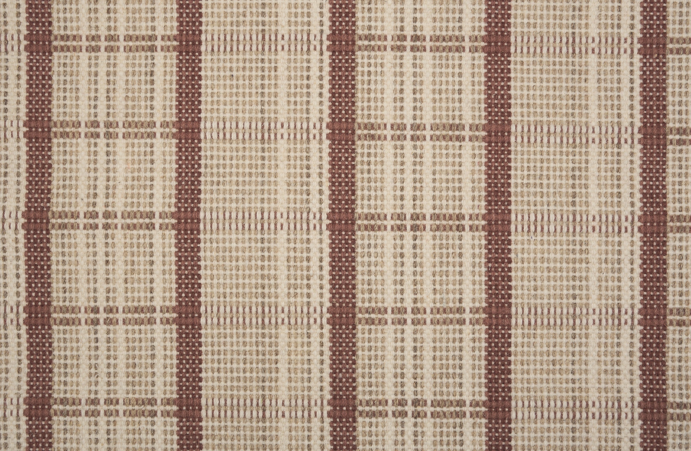 Broadloom carpet in a windowpane plaid in beige and rust red.