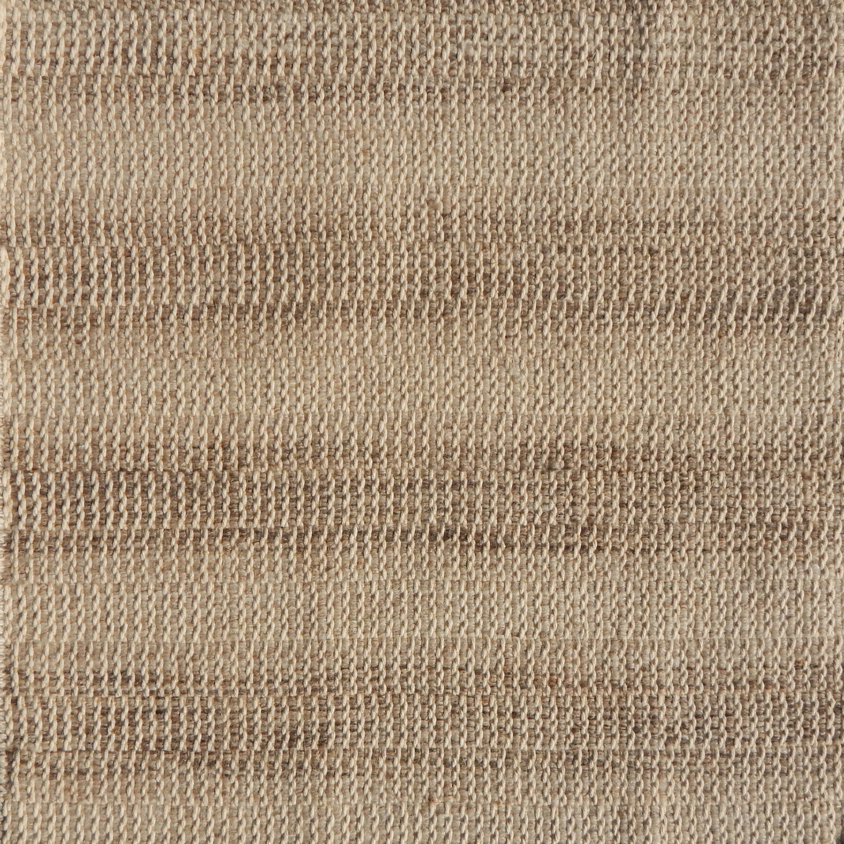 Flatweave rug in a textural stripe in shades of tan.