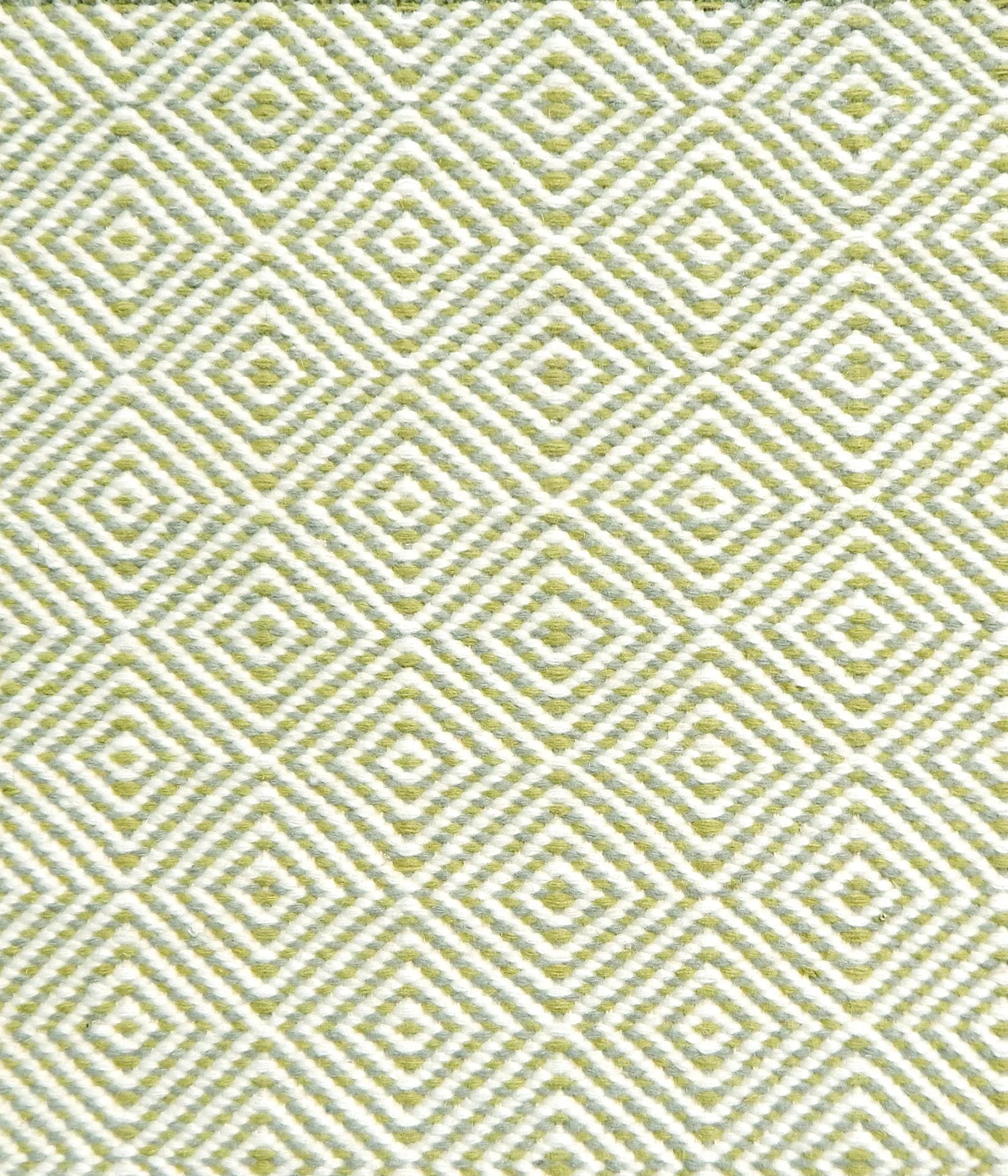 Handmade rug with concentric diamond pattern in white with lime green. 