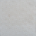 Patterned rug with a geometric diamond design in beige and cream
