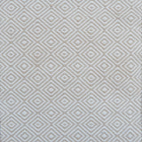 Patterned rug with a geometric diamond design in beige and cream