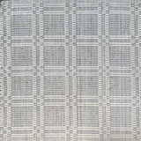Woven rug in a plaid check in slate blue and white. 