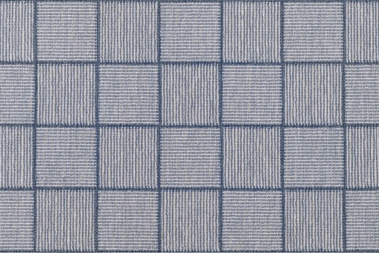 Broadloom carpet in a square grid with checkerboard stripes in shades of blue. 