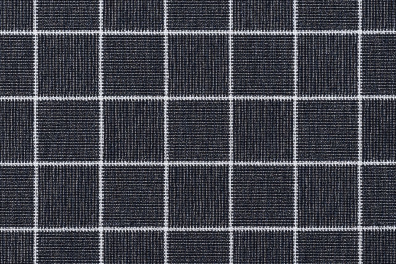 Broadloom carpet in a square grid with checkerboard stripes in black and white.