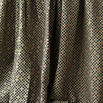 A row of draped jacquard fabrics, all in checked patterns in various colorways.