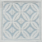Handmade rug with classic circle lattice design in white on a blue field. 