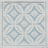 Handmade rug with classic circle lattice design in white on a blue field. 