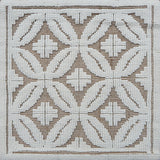 Handmade rug with classic circle lattice design in white on a tan field. 