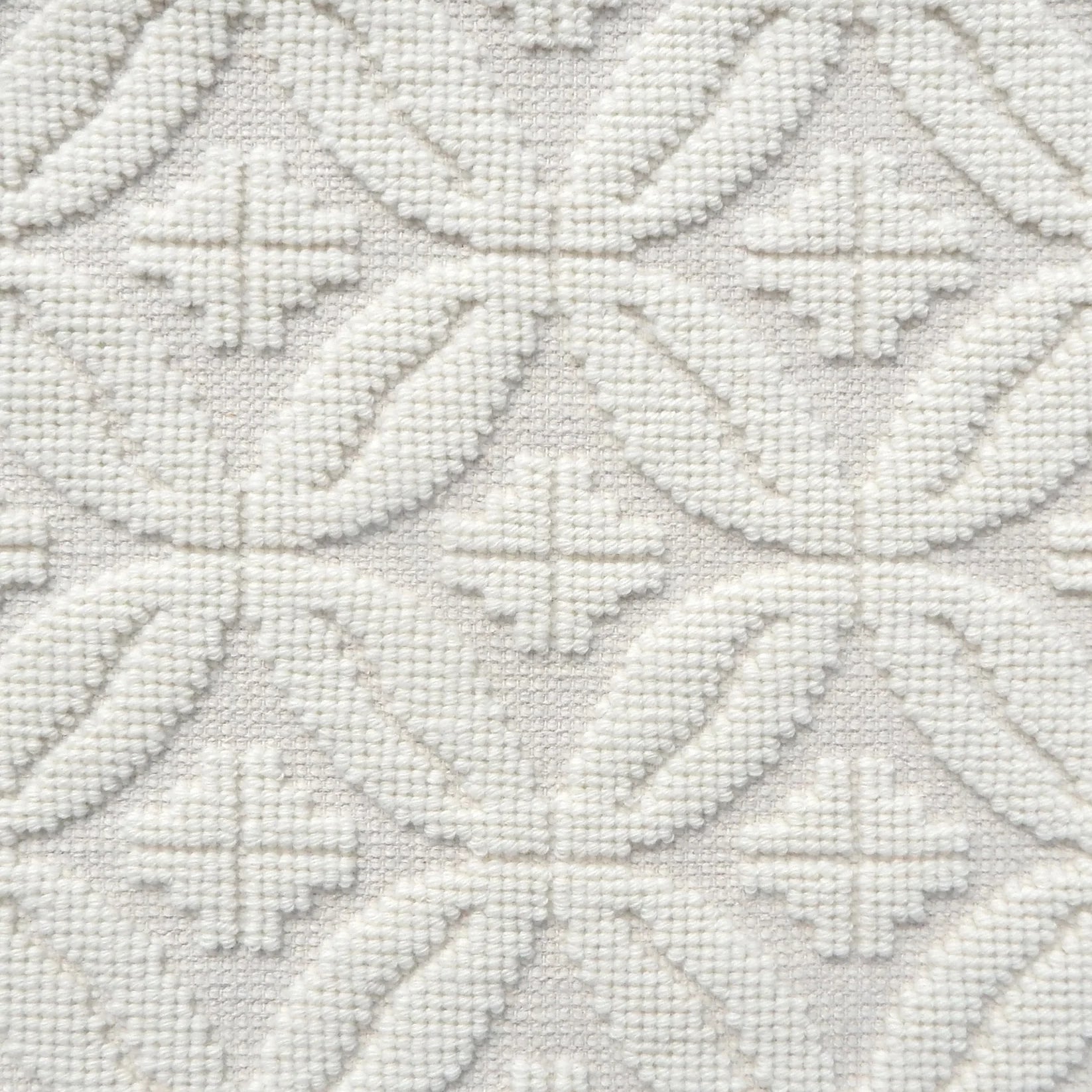 Handmade rug with classic circle lattice design in white. 