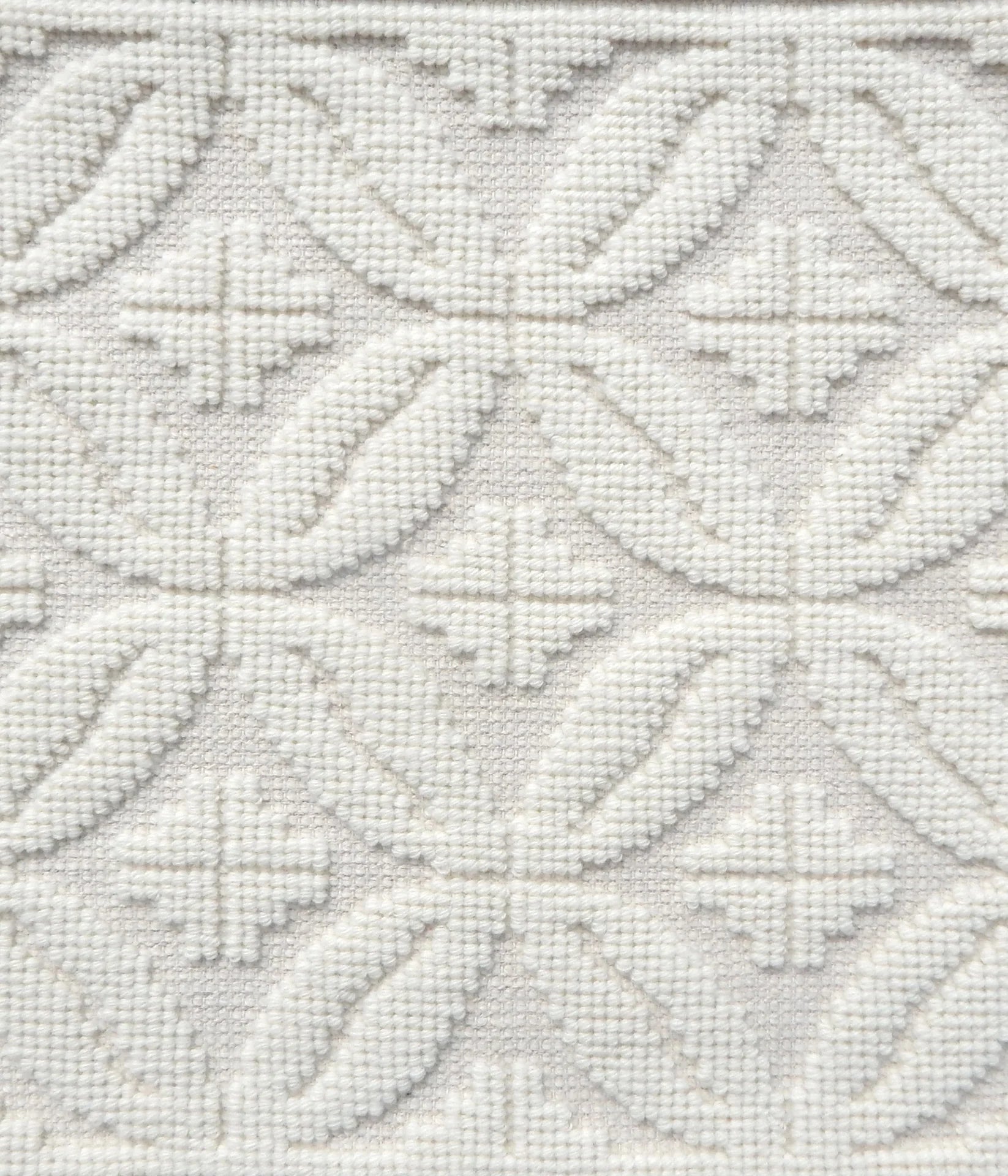 Handmade rug with classic circle lattice design in white. 