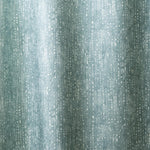 Draped linen in a painterly small-scale dashed dot print in white on a soft peacock blue watercolor field.