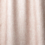 Draped linen in a painterly small-scale dashed dot print in white on a soft pink watercolor field.