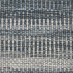 Handwoven rug detail in a textural stripe design in slate and grey