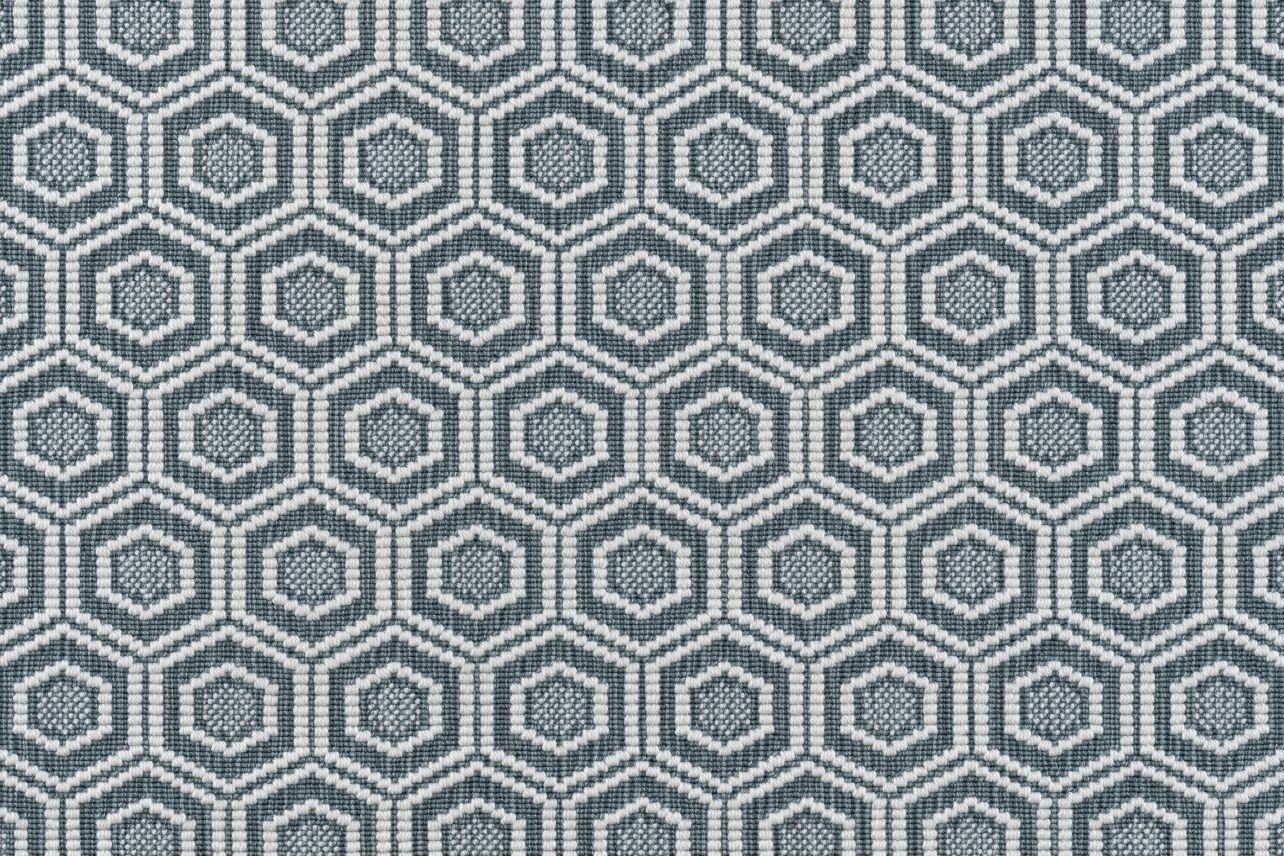 Broadloom carpet in a dimensional hexagonal lattice in white and teal.
