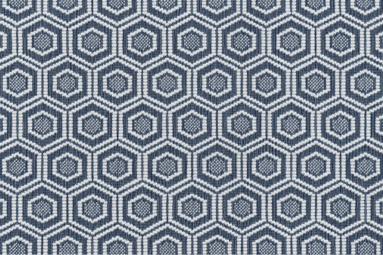 Broadloom carpet in a dimensional hexagonal lattice in white and navy blue.