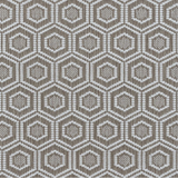 Broadloom carpet in a dimensional hexagonal lattice in white and warm tan.