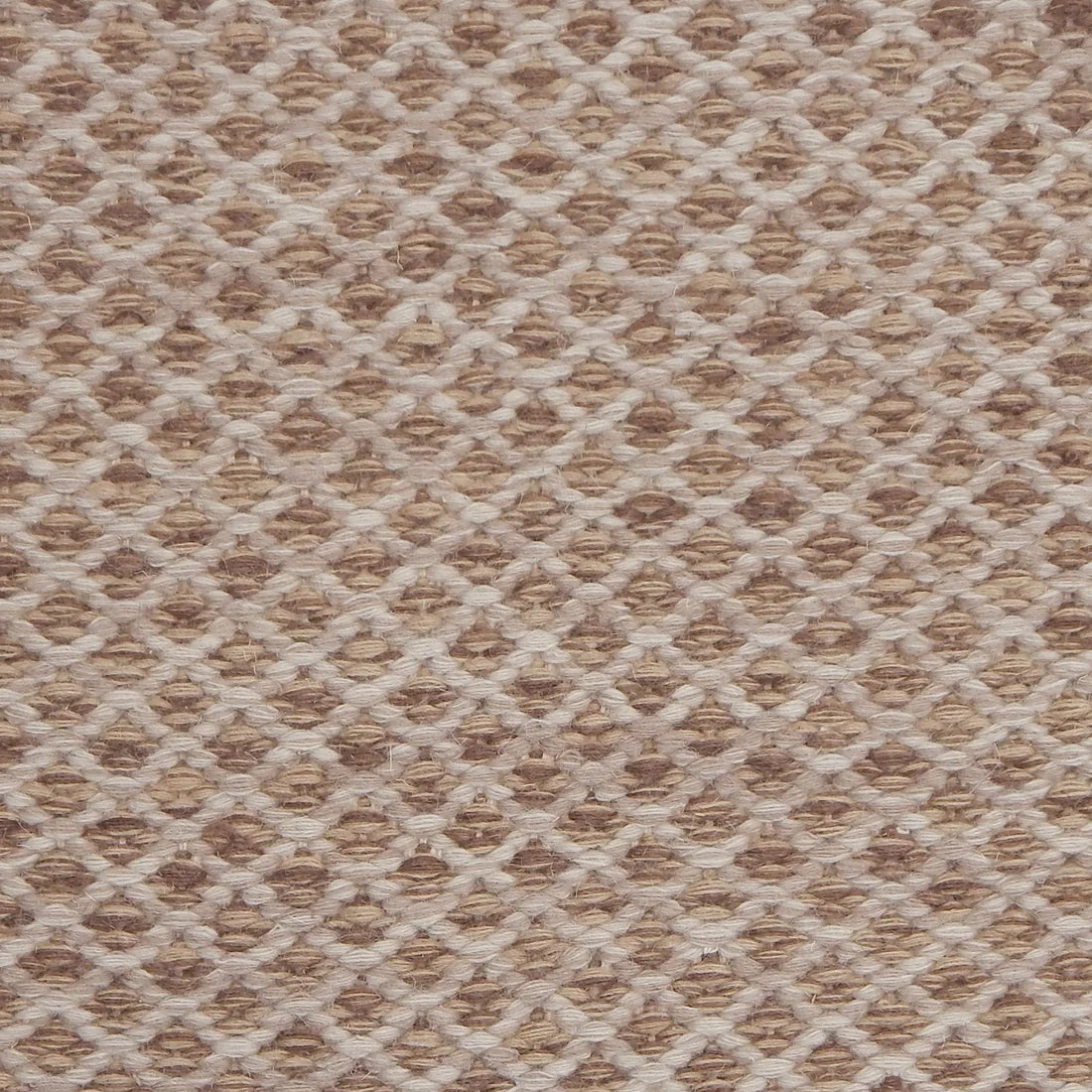 Handwoven rug with small scale diamond lattice in cream on a tan and brown field. 