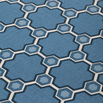 Fabric yardage in a geometric honeycomb pattern in shades of blue, cream and charcoal.