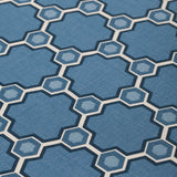 Fabric yardage in a geometric honeycomb pattern in shades of blue, cream and charcoal.