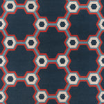 Flatwoven rug in a bold geometric floral-like design in blue, navy, red and cream. 