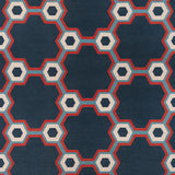 Flatwoven rug in a bold geometric floral-like design in blue, navy, red and cream. 