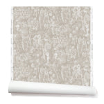 Partially unrolled wallpaper with a pattern of repeating watercolor illustrations of horses, farmers and country houses in white on a tan background.