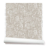 Partially unrolled wallpaper with a pattern of repeating watercolor illustrations of horses, farmers and country houses in white on a tan background.