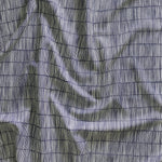 Close up of gently draped printed linen with thin hand drawn stripe grid in ivory on navy blue.