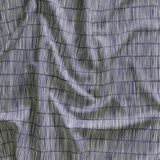Close up of gently draped printed linen with thin hand drawn stripe grid in ivory on navy blue.