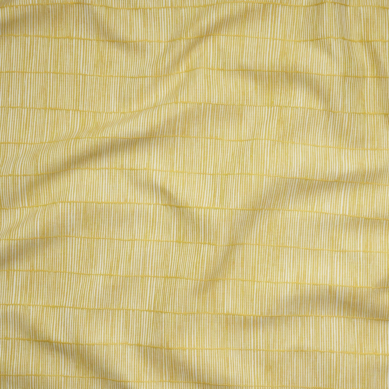 Close up of gently draped woven Indoor-Outdoor fabric with thin hand drawn stripe grid in ivory on yellow.