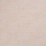 Detail of a printed linen fabric in a repeating camellia pattern in white on a light pink field.