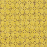 Detail of fabric in a botanical lattice print in brown on a mottled yellow field.