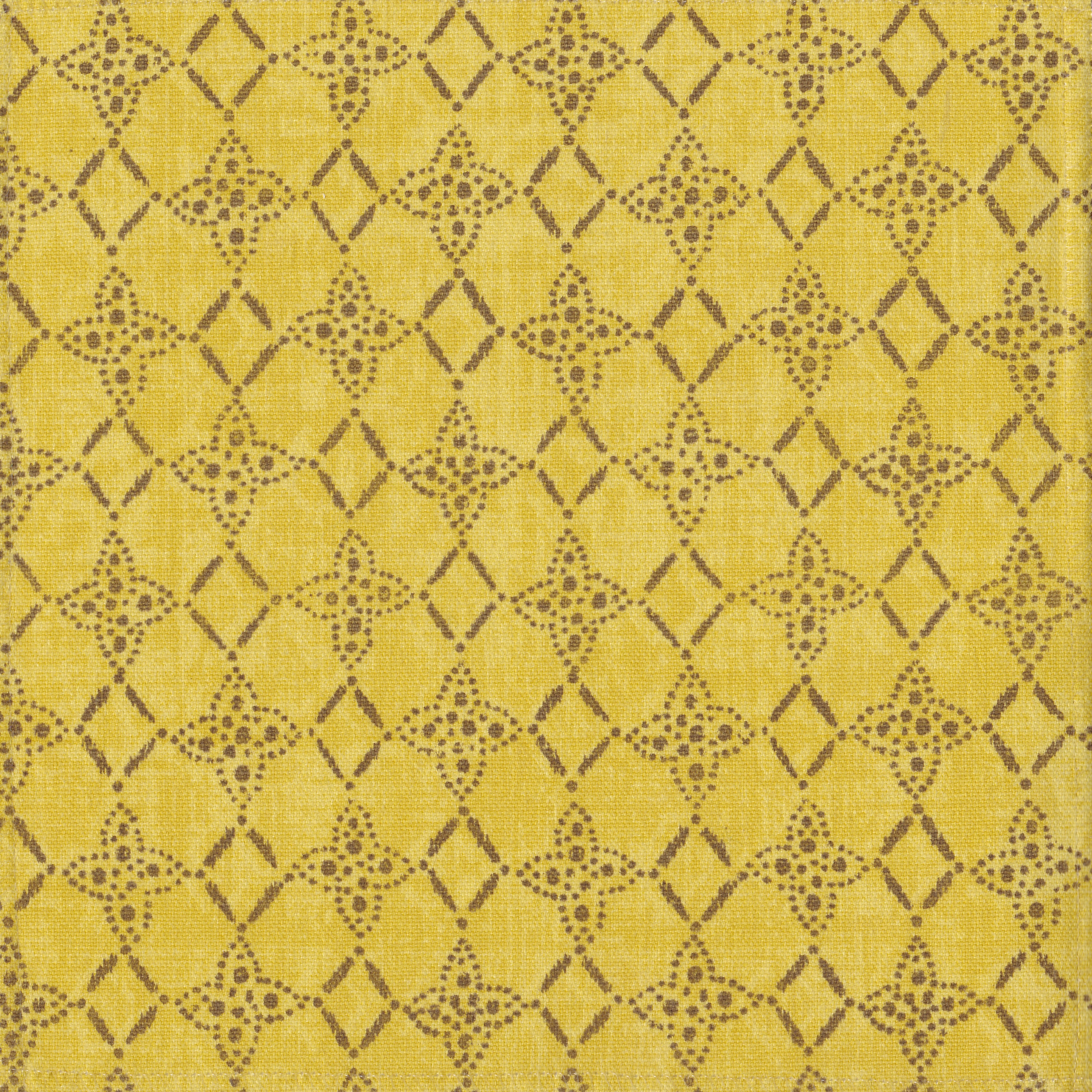 Detail of fabric in a botanical lattice print in brown on a mottled yellow field.