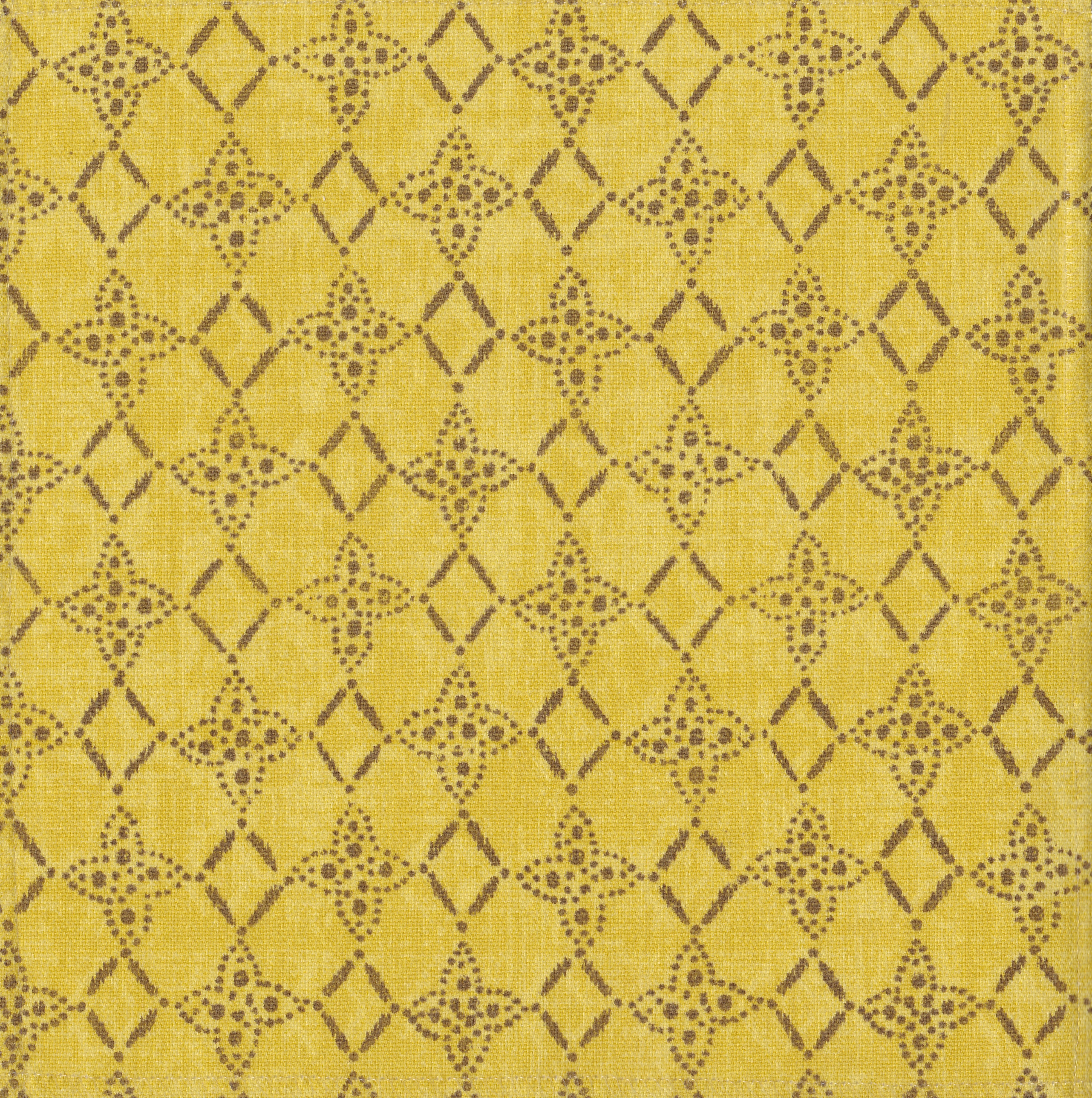 Detail of fabric in a botanical lattice print in brown on a mottled yellow field.