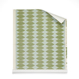 Roll of wallpaper with linear stacked diamond stripe in green on light blue.