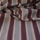 Draped Close-up of striped fabric with mixed color stripes. 