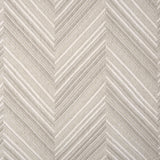 Broadloom carpet with a graphic herringbone pattern in shades of taupe. 