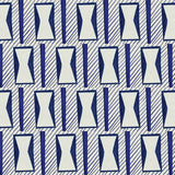 A close-up of a patterned wallpaper featuring a repeating geometric design of white hourglass-like shapes outlined in blue, set against a light gray background with diagonal blue stripes.