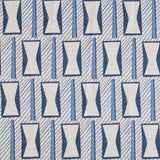 A close-up of a patterned fabric featuring a repeating geometric design of white hourglass-like shapes outlined in blue, set against a light gray background with diagonal blue stripes.