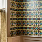 Room with a colorful geometric patterned wallpaper on the wall.