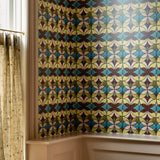 Room with a colorful geometric patterned wallpaper on the wall.