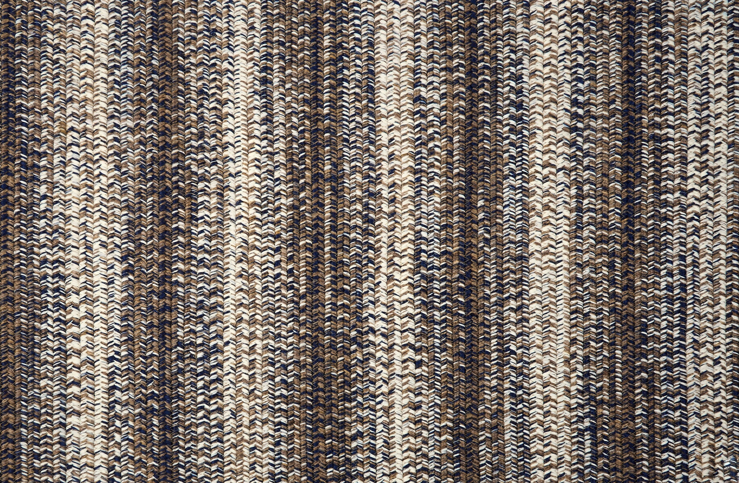 Broadloom carpet in a textural braided stripe in cream and brown.