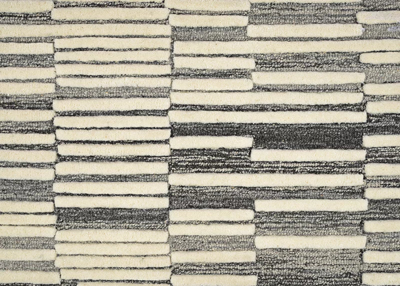 Broadloom carpet in a raised broken stripe pattern in cream on a charcoal grey field