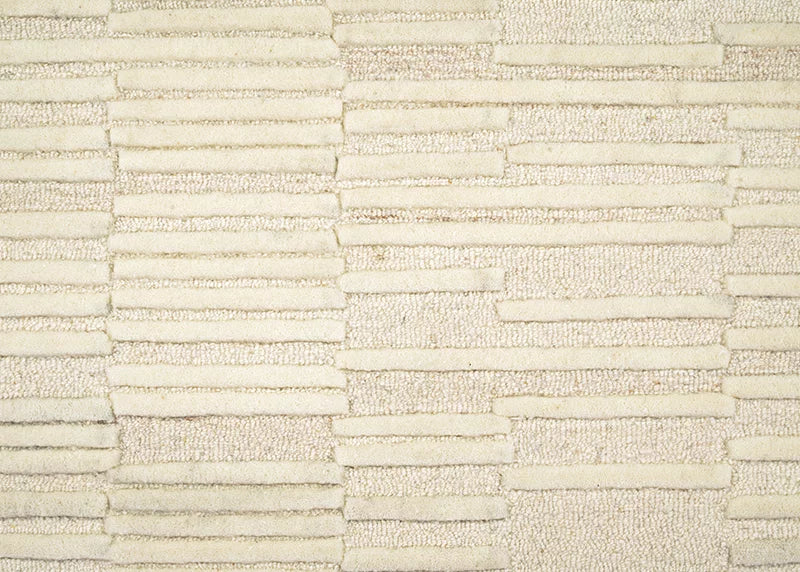 Broadloom carpet in a raised broken stripe pattern in cream on a cream field.