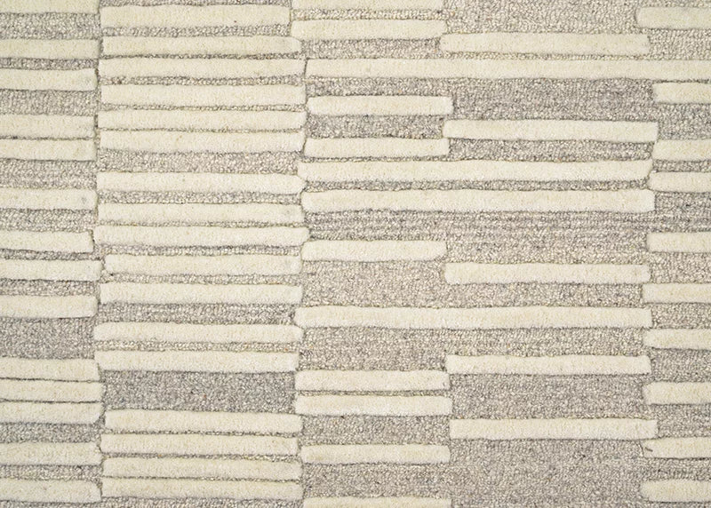 Broadloom carpet in a raised broken stripe pattern in cream on a grey field