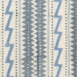 Fabric in a playful stripe and zigzag pattern in shades of gray and blue on a cream field.