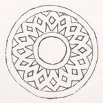 Detail of fabric in a repeating circular geometric print in gray on a white field.