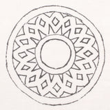 Detail of fabric in a repeating circular geometric print in gray on a white field.