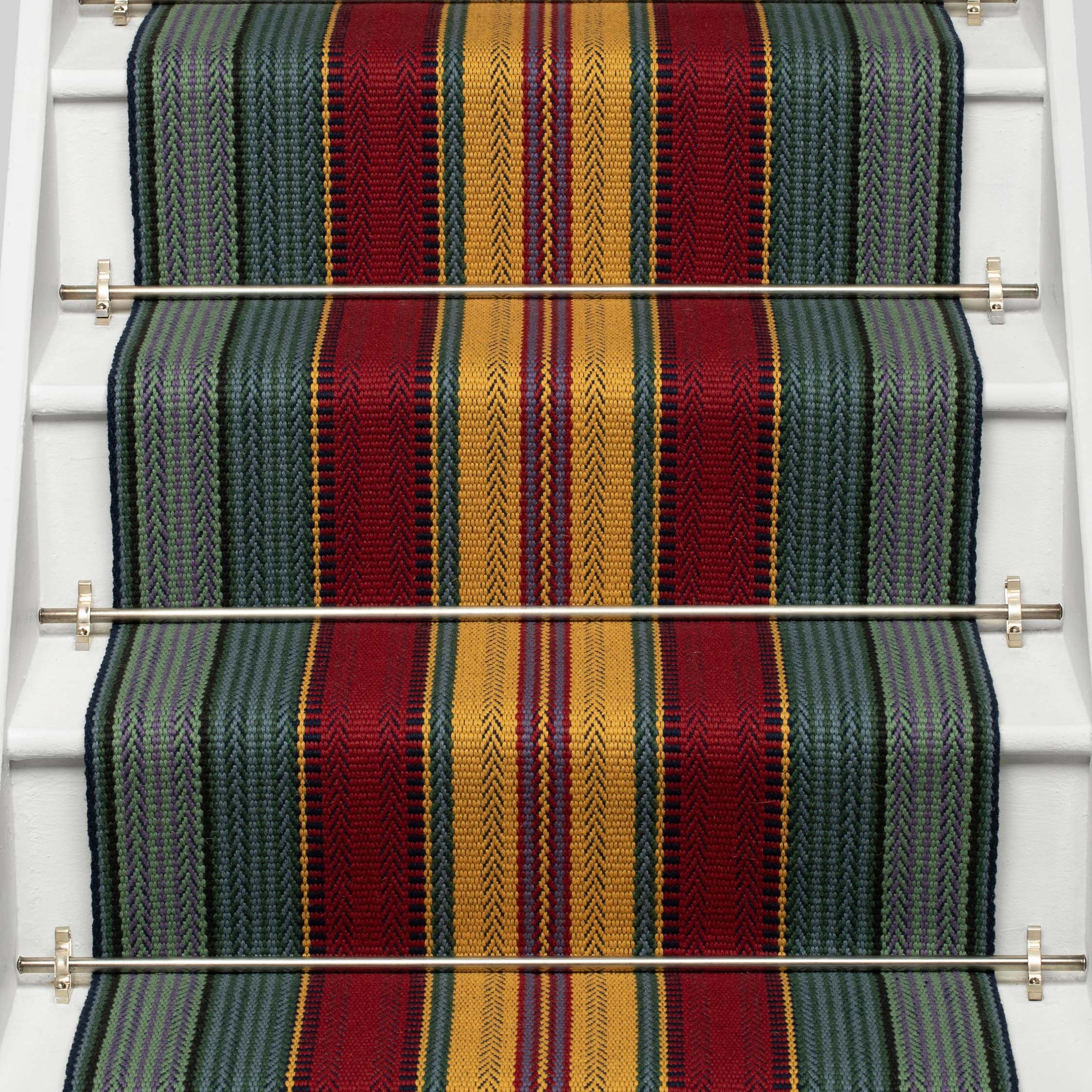 Striped flatweave runner in red yellow green and blue on white staircase